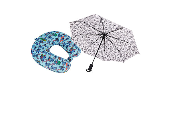 Blue patterned travel pillow and floral umbrella on a white background